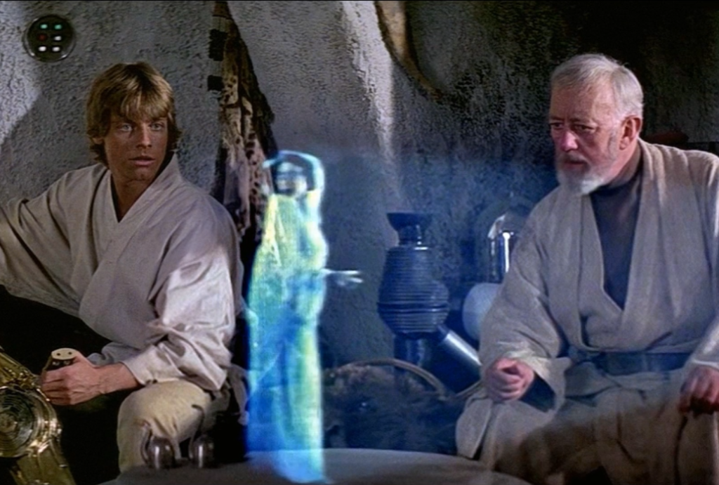 Hologrammikohtaus Tähtien sota IV - Uusi toivo -elokuvasta. Vasemmalla Luke Skywalker, oikealla Obi-Wan Kenobi. Keskellä sinertävä hologrammi prinsessa Leiasta.
