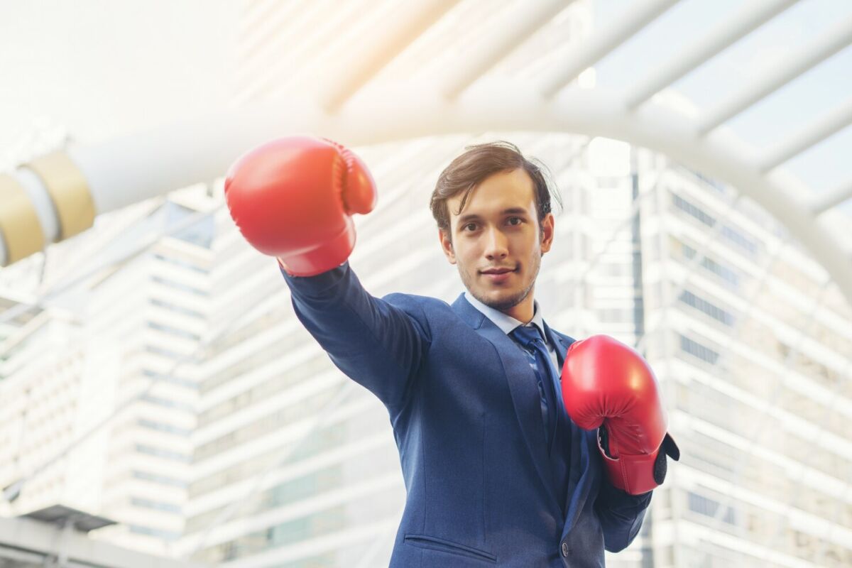 Man wearing a suit and boxing gloves