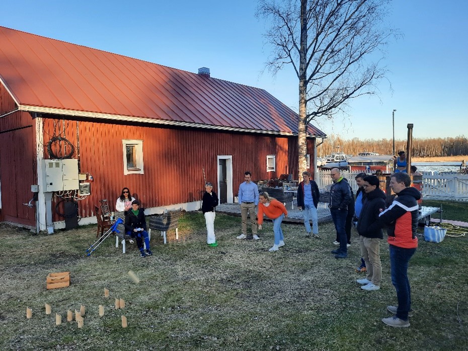 Peoople playing a game with wooden blocks on the yard